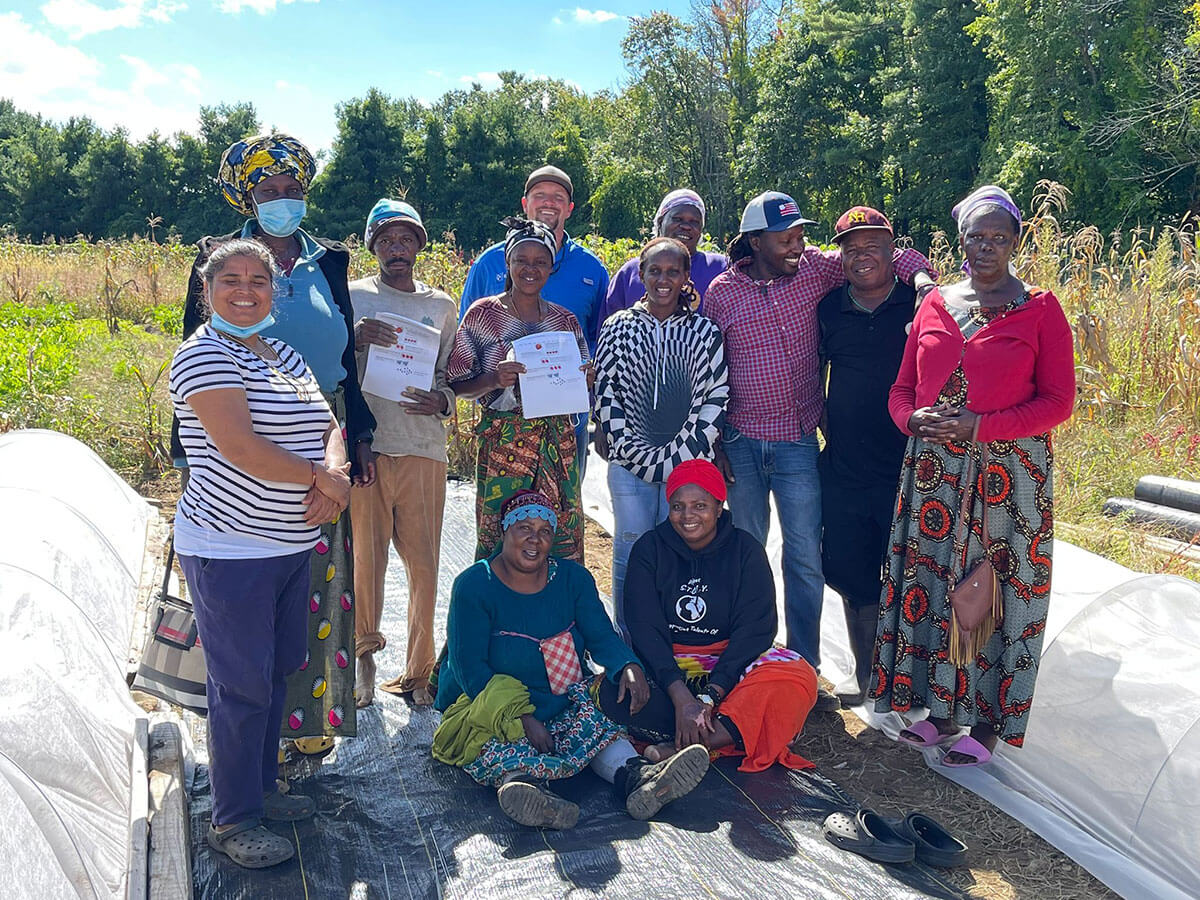 Group of mixed cultured people standing on a farm